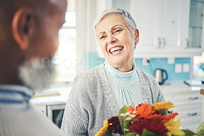Buy stock photo Love, gift and senior couple with flowers, smile and loving at home, bonding and romance. Romantic, man and woman with floral present, celebrate anniversary and relationship with joy and quality time