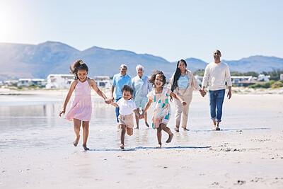 Buy stock photo Beach, big family and children holding hands, running and happiness on summer vacation together in Mexico. Sunshine, fun and bonding, men, women and kids on holiday walk on happy morning with energy.