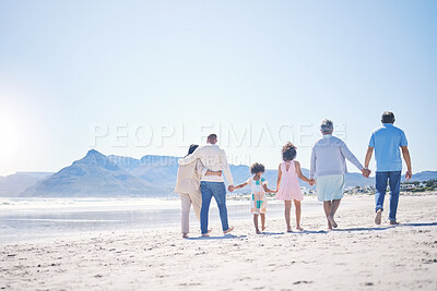 Buy stock photo Holding hands, back and big family at the beach for walking, holiday and summer weekend by the ocean. Affection, support and parents, children and grandparents on a walk by the seaside for bonding