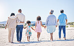 Holding hands, back and big family at the beach for holiday, walking and summer weekend by the ocean. Affection, support and parents, children and grandparents on a walk by the seaside for bonding
