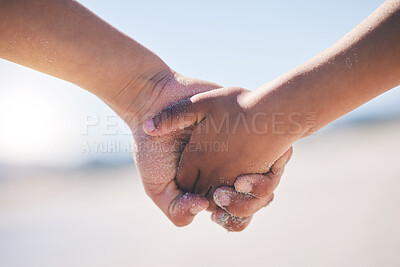 Buy stock photo Love, unity and couple holding hands at a beach with trust, solidarity and commitment in nature. Hand, care and man with woman on romantic walk at the sea, sweet and bonding while traveling together