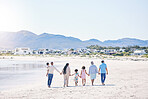 Family, holding hands and walk at beach with mockup space by water, together or bond with love in summer holiday. Men, women and children for support, vacation or ocean mock up with waves in sunshine