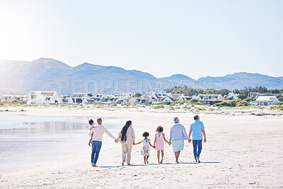 Buy stock photo Family, holding hands and walk at beach with mockup space by water, together or bond with love in summer holiday. Men, women and children for support, vacation or ocean mock up with waves in sunshine