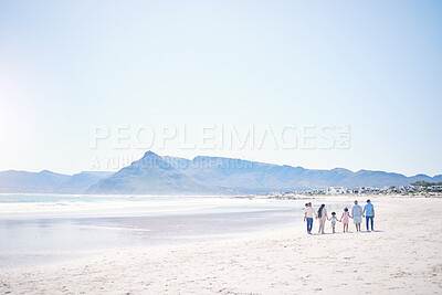 Buy stock photo Family, beach and holding hands with mockup space by blue sky, walking and bonding with love in summer holiday. Men, women and children for support, vacation and ocean mock up with waves in sunshine