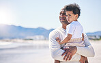 Father, holding boy and mockup space at beach with bond, care or love in summer sunshine on holiday. Man, male baby and hug with thinking, vision and family with support, sea vacation and mock up