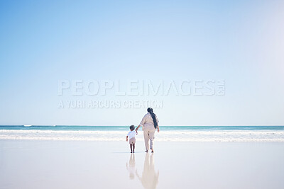 Buy stock photo Mother, son and beach with back, space and mock up with blue sky, lens flare and bonding with love in summer. Mama, male kid and holding hands for care, vacation and sea mockup with waves in sunshine