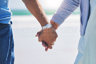 Buy stock photo Unity, love and couple holding hands at a beach with trust, solidarity and commitment in nature. Hand, care and man with woman on romantic walk at the sea, sweet and bonding while traveling together