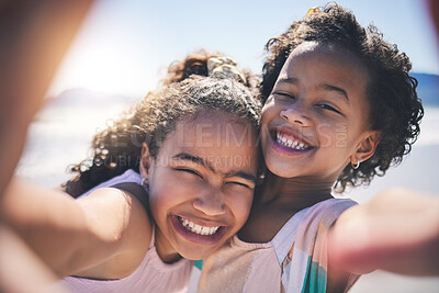 Buy stock photo Girl children, hug and selfie at beach with smile on face, sunshine or friends with fun, travel or summer on social media. Female kids, siblings or photography for profile picture, vacation or family