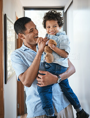 Buy stock photo Love, father and son with a hug, smile and bonding at home, cheerful and quality time. Family, male parent and boy with happiness, kid and child in the living room, joyful and embrace with affection