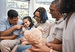 Love, children and teddy bear with a family on the sofa in the living room of their home together during a visit. Parents, grandparents and kids in the lounge of a house for bonding or relaxing