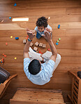 High five, toys and top view of father with baby on floor for playing, educational games and learning. Child development, family and above of happy dad and young boy for celebration, bonding and love