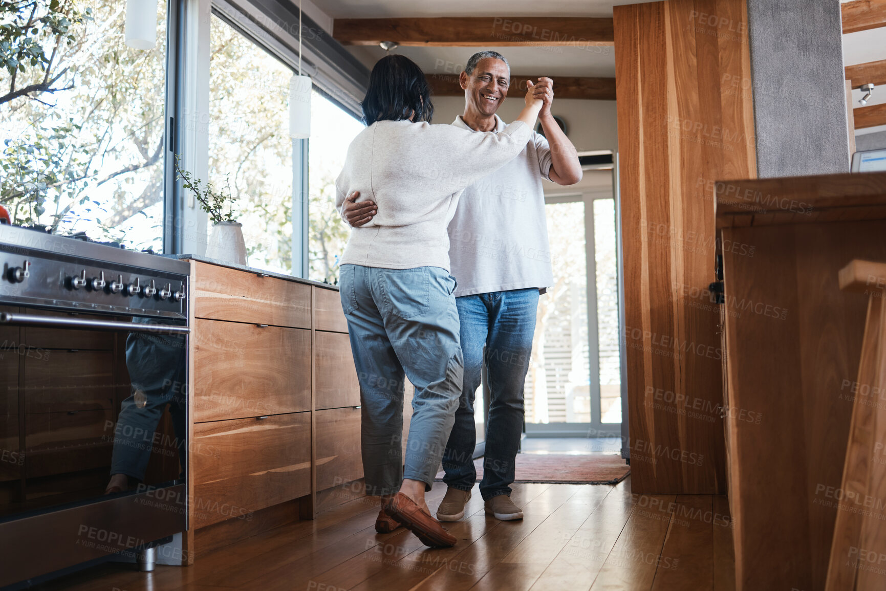 Buy stock photo Happy, dance and senior couple in a kitchen with a smile and joy from marriage and retirement. Elderly people, love and happiness of dancing at home with a old woman and man together with a laugh