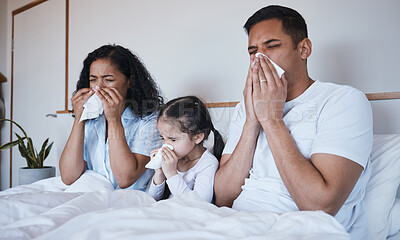 Buy stock photo Sick, family and blowing nose in bed in home lying in bedroom together in house. Flu, parents and child wipe with tissue with man, woman and girl with covid, virus or cold, disease or winter allergy