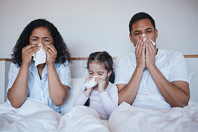 Buy stock photo Family, sick and blowing nose in bedroom in home lying on bed together in house. Flu, parents and child wipe with tissue with man, woman and girl with covid, virus or cold, disease or winter allergy.