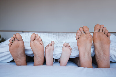 Buy stock photo Family feet, bed and home together with love, support and bonding in the morning. Sleep, bedroom and house with a mother, dad and child relax under a blanket with a foot from parents and kid
