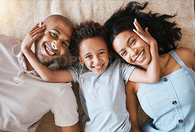 Buy stock photo Portrait, family and top view smile in home, bonding or having fun together. Parents, happiness and child relaxing or lying on ground or carpet floor with man and woman, care or enjoying quality time