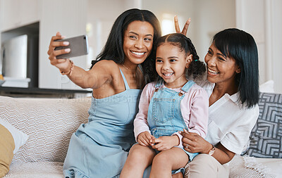 Buy stock photo Peace sign selfie, grandmother and kid with mother in home living room, bonding or having fun. Family, smile and girl with grandma and mama, care or taking pictures on sofa with v hand emoji together