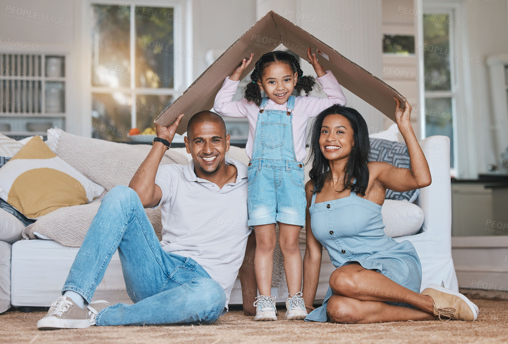 Buy stock photo Portrait, cardboard roof and family in the lounge, home insurance and care with protection, smile and safety. Face, parents or mother with father, girl and daughter in the living room, love and cover