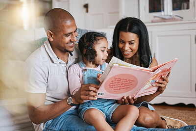 Buy stock photo Love, bonding and family reading a book together before bed in a bedroom in the modern house. Happy, smile and girl kid enjoying a fantasy novel or story with her mother and father in their home.