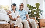 Portrait, senior couple and smile in home living room on sofa, bonding and embrace in house. Couch, retirement and happiness of man and woman relaxing and enjoying quality time together in lounge.
