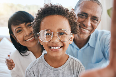 Buy stock photo Glasses, grandparents and selfie smile with kid in home living room, bonding and having fun. Photo, happiness and portrait of child with grandma and grandpa taking face pictures for family memory.