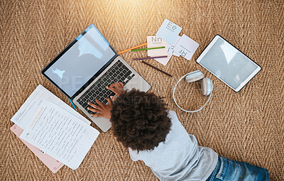 Buy stock photo Online education, laptop and child on floor for e learning, language translation and typing on kids website. Kid relax on carpet with computer, headphones and digital tech for home development above