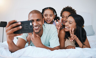 Buy stock photo Selfie smile, family and peace sign in bedroom, bonding and relaxing together in home. Bed, photo and children with mother and father taking pictures for happy memory, social media or v hand emoji.