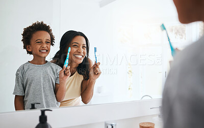 Buy stock photo Teaching, mama and son brushing teeth, wellness and cleaning mouth at home, bathroom and smile. Family, female parent and mother with male child, kid and boy with reflection, health or dental hygiene