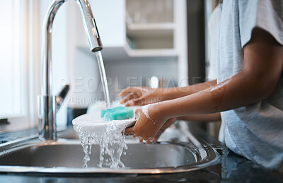 Buy stock photo Hands, sink and washing dishes with a person in the kitchen of a home to wash a plate for hygiene. Water, bacteria and soap with an adult cleaning porcelain crockery in a house to clean for housework