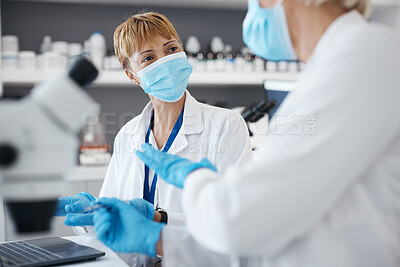 Buy stock photo Science, talking and women in laboratory for research, investigation or collaboration. Expert medical team in lab with equipment for innovation, future medicine or biotechnology study with face mask