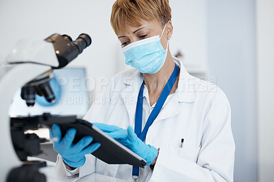 Buy stock photo Scientist, tablet and woman with mask in research for cure, results or data at the laboratory. Female medical or science professional working on technology in forensics for scientific search in a lab