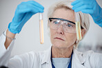 Senior woman, scientist and vials for chemical experiment or testing with gloves in laboratory. Mature female in science discovery or scientific research with test tubes for chemistry results in lab