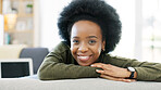 Face of a happy woman relaxing indoors on the weekend. Beautiful, cheerful and carefree African American girl having a stressless day at home relaxing in her modern bright living room apartment