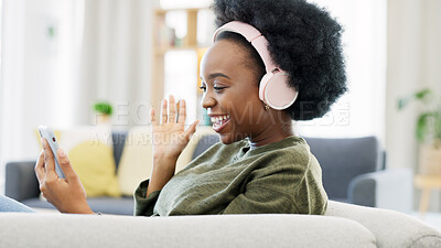 Buy stock photo Woman, headphones and video call on smartphone, social network or mobile contact at home. Happy african person wave hello for talking on cellphone with voip communication, digital app or virtual chat