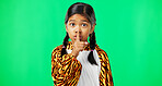 Secret, green screen and face of a child in studio with her finger on her lip for a quiet gesture. Noise, young and portrait of girl kid posing with silence or hush hand sign by chroma key background