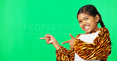 Buy stock photo Girl child, point and sign by green screen, portrait and smile for review, suggestion and studio background. Kid, tiger suit or mockup space with gesture, feedback or happy for choice, deal or promo