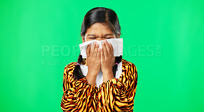 Children, covid and blowing nose with a girl on a green screen background suffering from allergies. Portrait, kids and sick with a little female child sneezing from infection, pollen or hayfever