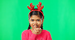 Shush, Christmas and secret with girl in green screen studio for holiday, gossip and gift. Surprise, festive and announcement with child isolated in background for celebration, privacy and present