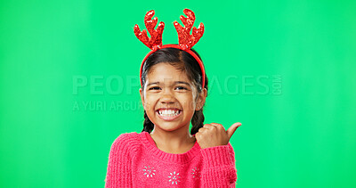 Buy stock photo Girl, christmas or green screen with smile, reindeer antlers or pointing chromakey space. Portrait, holidays and kid with happiness, mockup and festive season for holiday celebration, excited or face