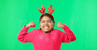 Child portrait, christmas and antlers on green screen flexing strong muscles or arms for motivation. Smile on face of a girl kid on a studio background with reindeer headband for holiday celebration