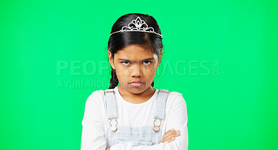 Angry, upset and child with crossed arms on green screen with crown, princess costume and tutu in studio. Portrait, behavior mockup and isolated young girl with anger, disappointed and mad expression
