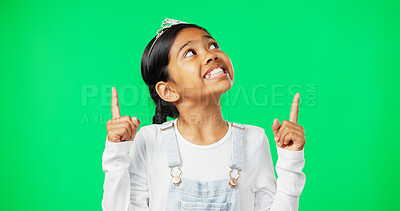 Buy stock photo Green screen, mockup and girl child pointing up happy, excited and isolated in a studio background. Deal, sale and young female or kid hands showing at brand, product placement or branding logo