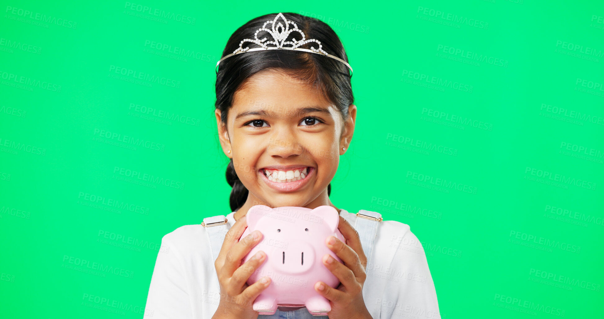 Buy stock photo Girl child, green screen and piggy bank with smile, portrait and savings with crown for princess costume. Kid, tiara and container for investing, goals or mockup for financial learning by background