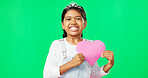 Portrait, heart and emoji with a girl on a green screen background for the celebration of valentines day. Kids, happy and love with a cute little female child holding a cardboard shape on chromakey