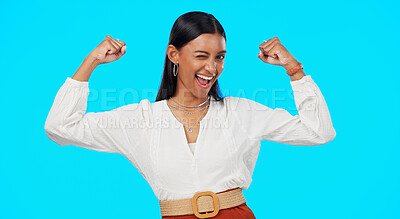 Buy stock photo Strong, muscle and woman wink in studio isolated on blue background excited and happy. Bonus, prize or Indian person with success, competition or flexing arms for promo sale and winning giveaway