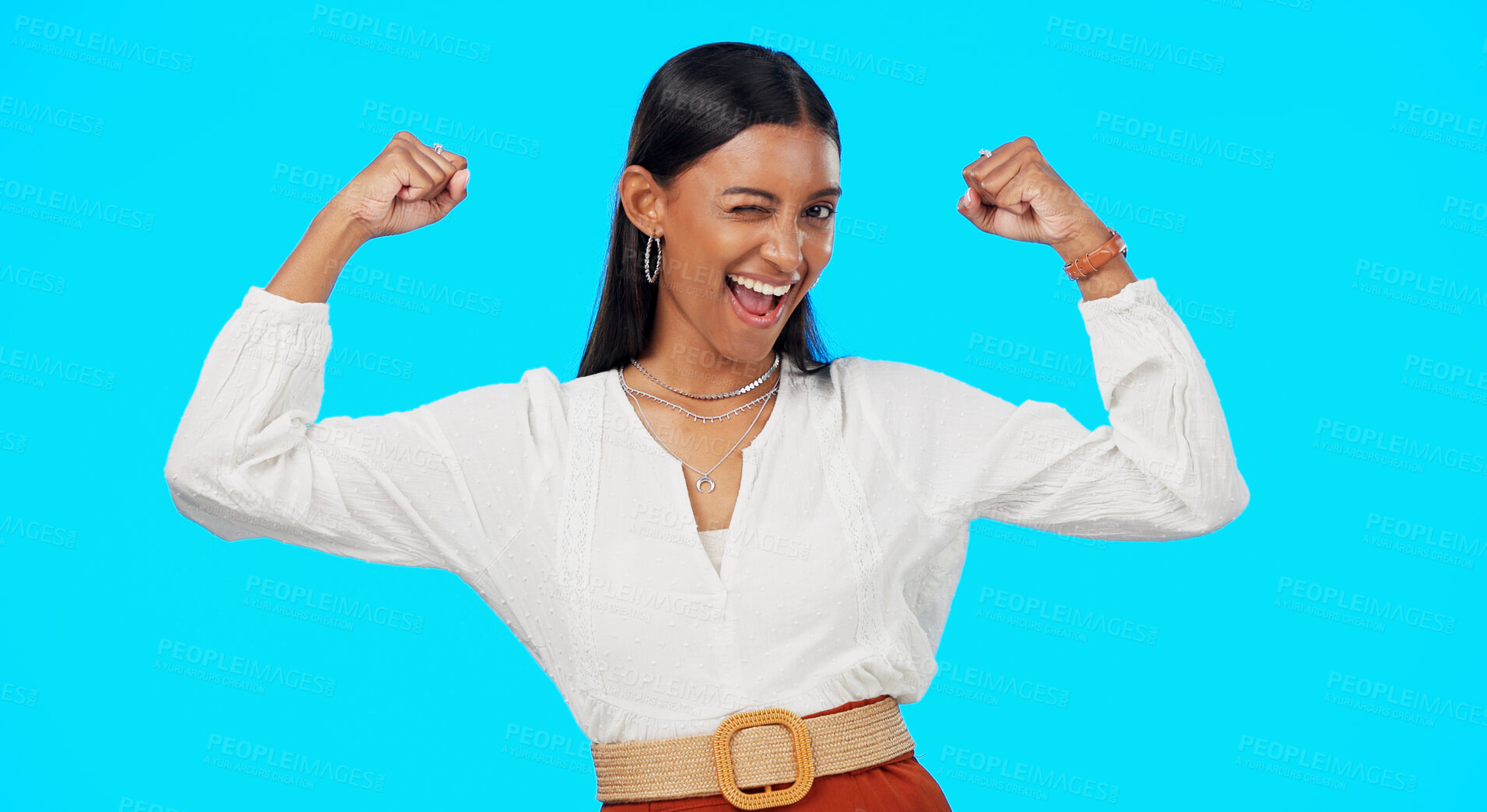 Buy stock photo Strong, muscle and woman wink in studio isolated on blue background excited and happy. Bonus, prize or Indian person with success, competition or flexing arms for promo sale and winning giveaway