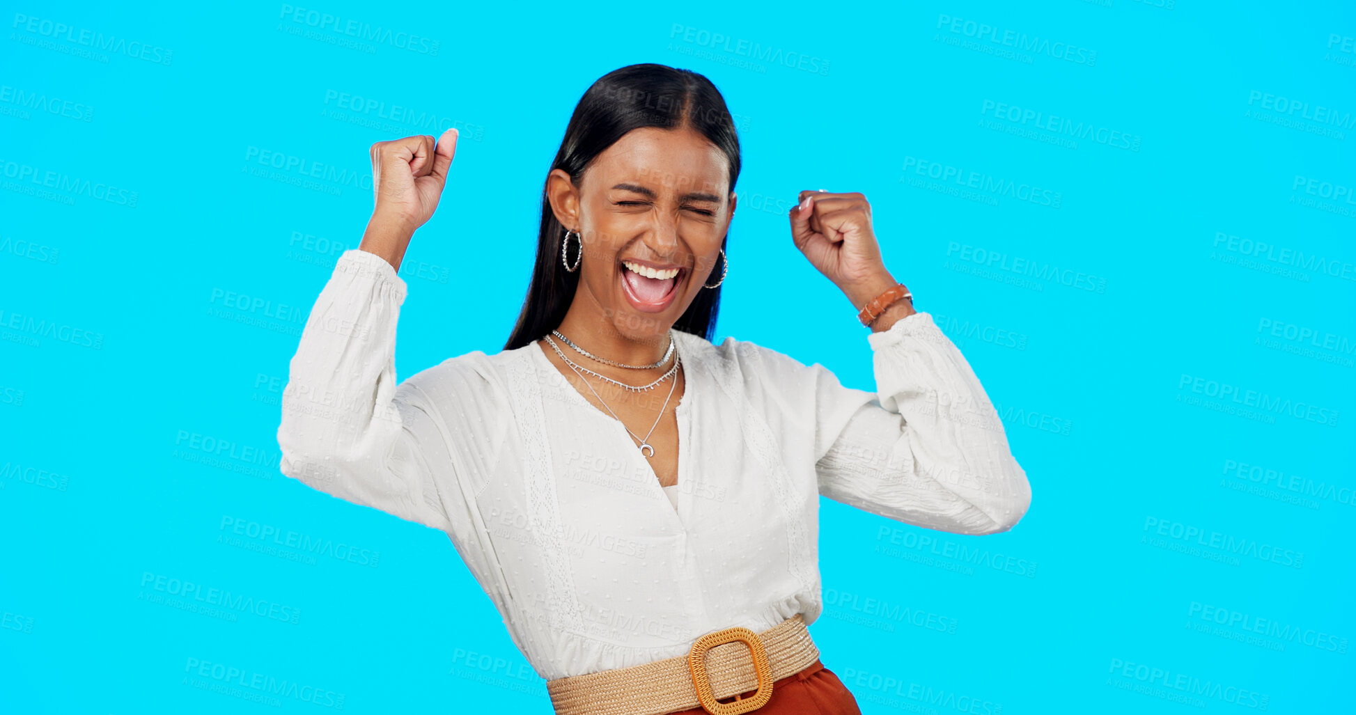 Buy stock photo Celebrate, winning and fist of woman with promotion isolated in studio blue background excited and happy. Bonus, prize or Indian person with success, competition or news for promo sale and giveaway