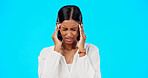 Woman, headache and studio with hands, migraine and stress on head to massage temple by blue background. Young indian model, pain and anxiety with mental health, fatigue and burnout by backdrop