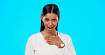 Shocked, surprised and woman portrait of wow face in studio on a blue background for announcement or news. Indian female model with hand on chest for attitude, compliment or emoji for gossip or rumour