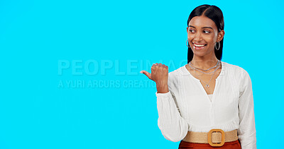 Buy stock photo Advertising studio, happiness and woman point at ads commercial, retail store promotion or news direction. Mockup space, consumer choice presentation and brand ambassador offer on blue background